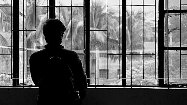 Silhouette figure barred window