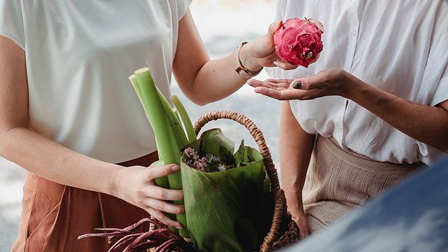 Hands exchange dragonfruit