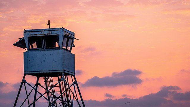 Lifeguard tower pink sunset